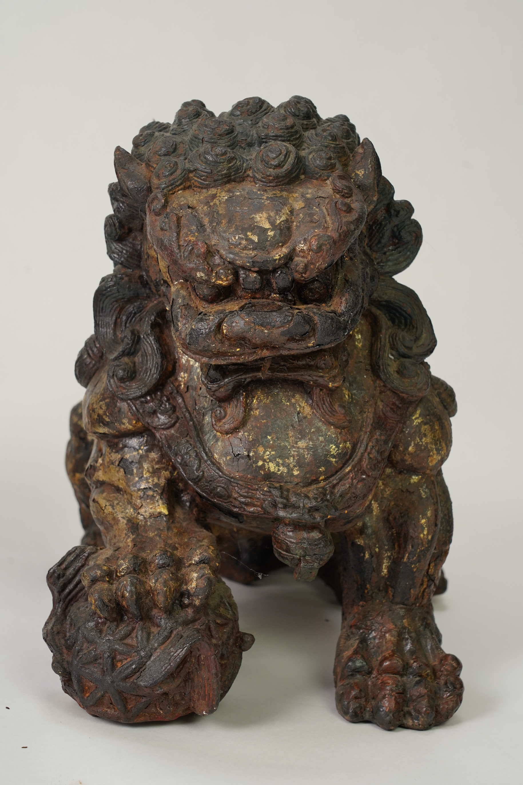 A pair of large Chinese polychrome lacquered cast iron models of lion temple guardians, Qing dynasty